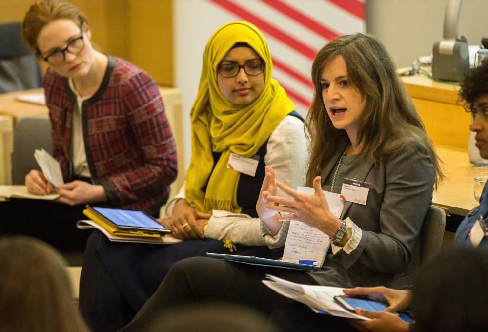 Kate Orkin talks on a panel in a forum